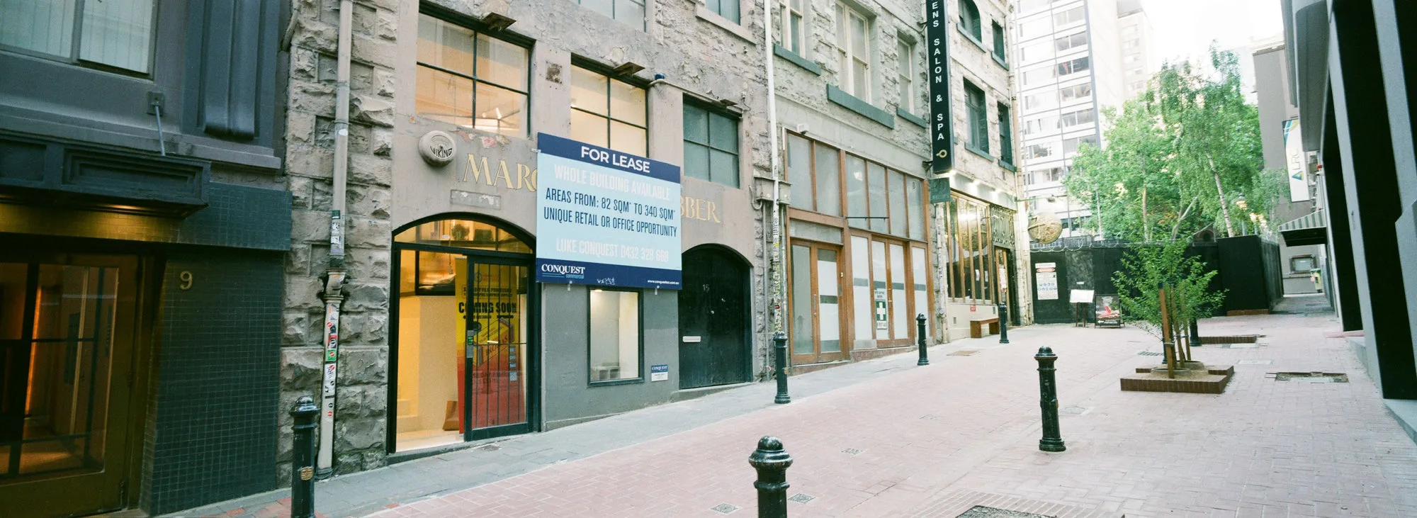 McKillop Street, with the Melbourne lab behind a Coming Soon poster